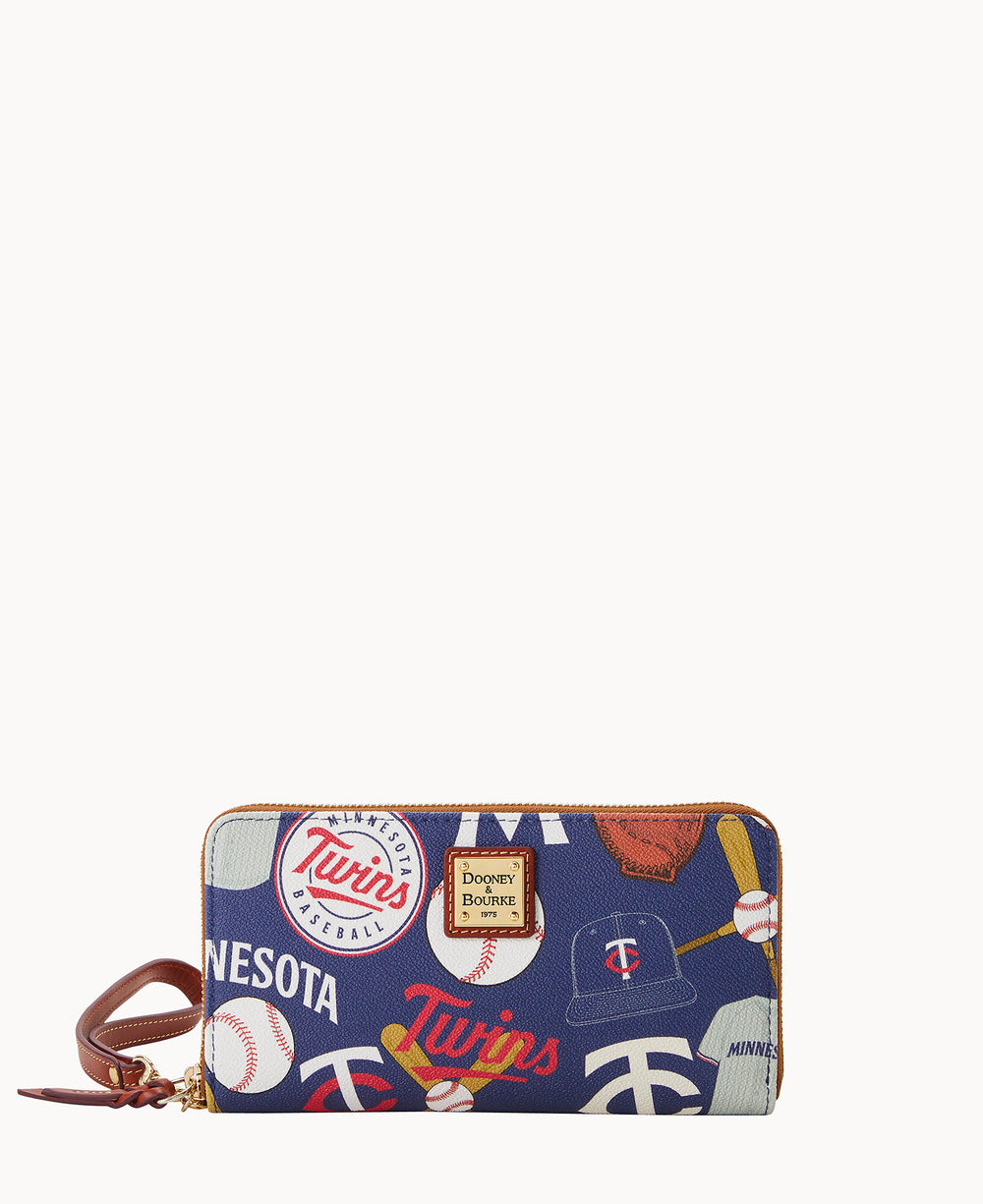 A navy blue wristlet wallet decorated with Minnesota Twins baseball-themed graphics, including team logos, baseballs, bats, and hats. The wallet has a brown leather strap and a gold Dooney & Bourke logo plate.