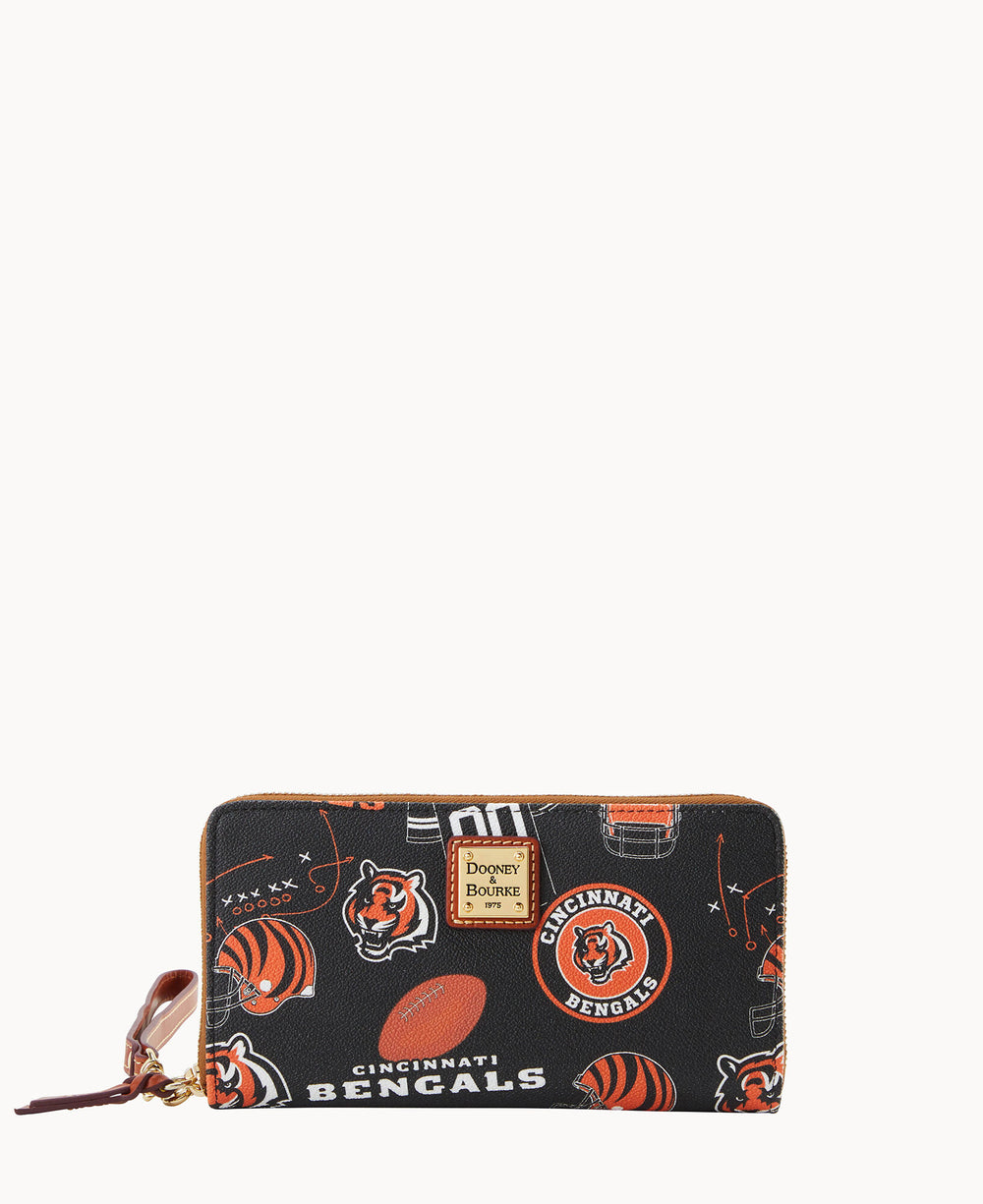 A black Dooney & Bourke wallet features multiple Cincinnati Bengals logos, tiger mascots, footballs, and the team name in orange, white, and black, with a brown leather wrist strap and gold logo plate.