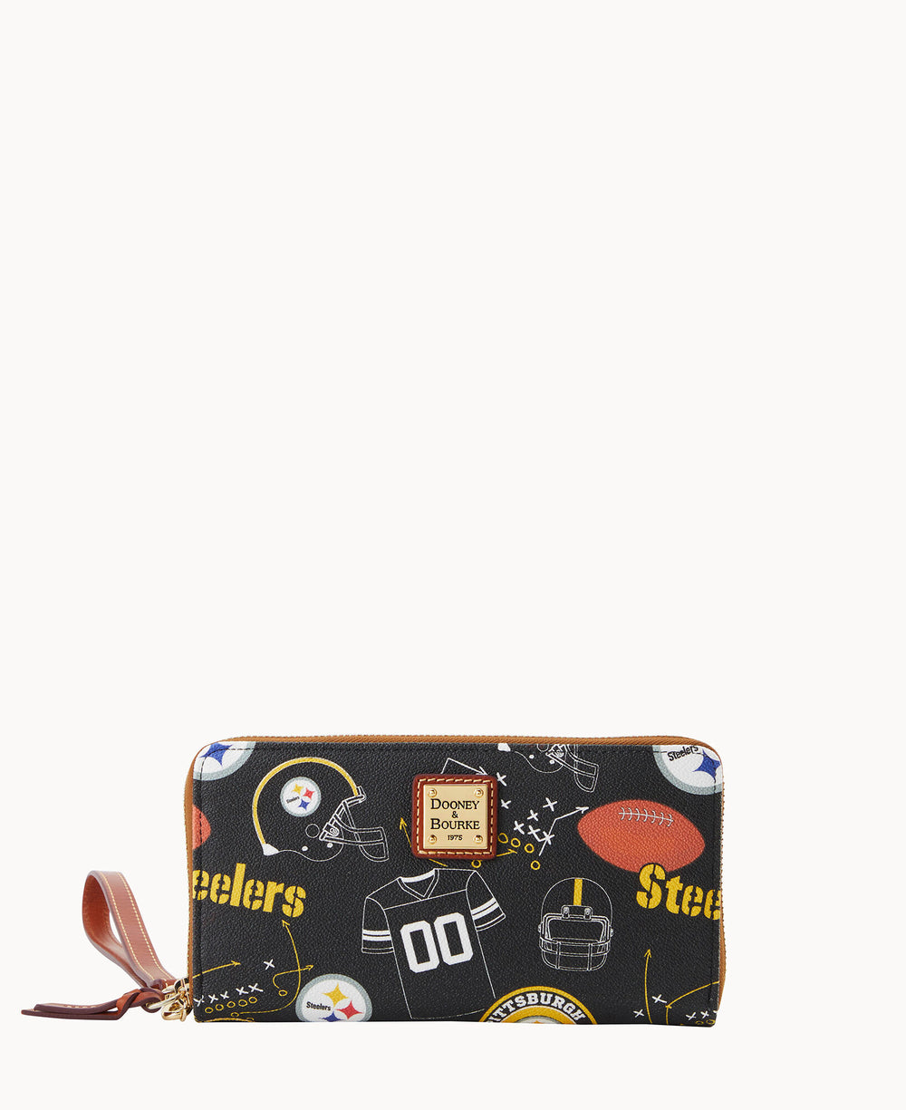A black Dooney & Bourke wallet decorated with Pittsburgh Steelers-themed graphics, including helmets, footballs, and the Steelers logo, with a brown leather zipper pull.