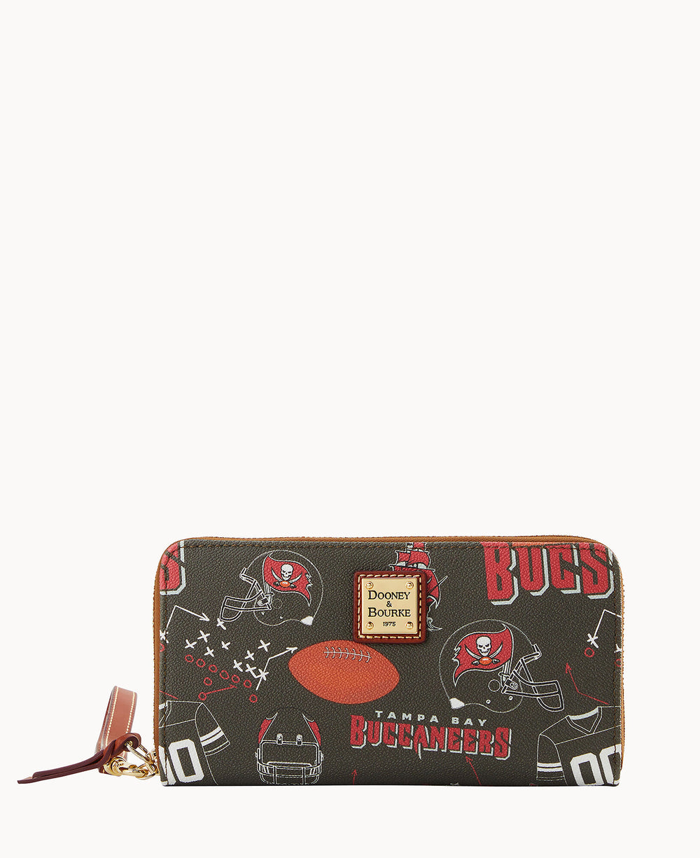 A zip-around wallet featuring Tampa Bay Buccaneers-themed graphics, including helmets, footballs, and the team logo, with a gold Dooney & Bourke label on the front.