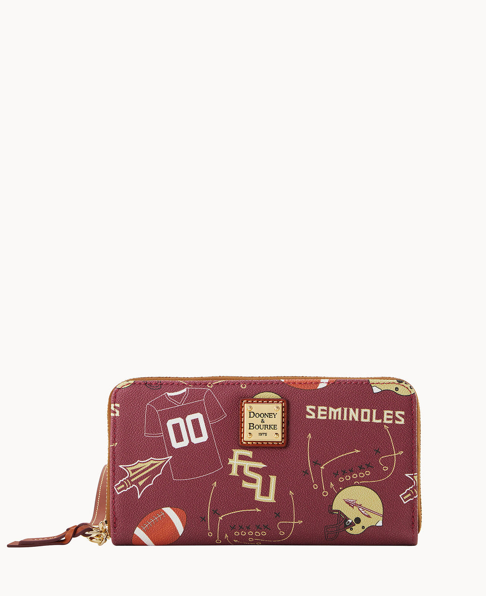 A maroon Dooney & Bourke wallet with Florida State University Seminoles-themed graphics, including a football jersey, helmet, play diagram, and â€œSEMINOLESâ€ text. The wallet has a gold zipper and a logo patch.