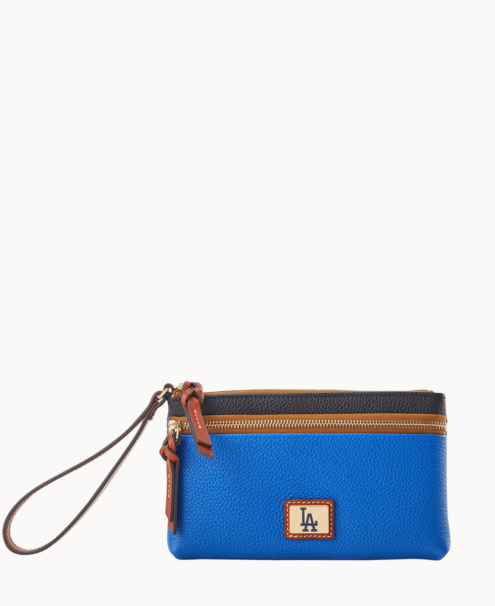 A blue wristlet clutch with brown leather accents, a zipper closure, and a brown LA logo patch on the front. The wristlet strap is attached to the zipper pull.