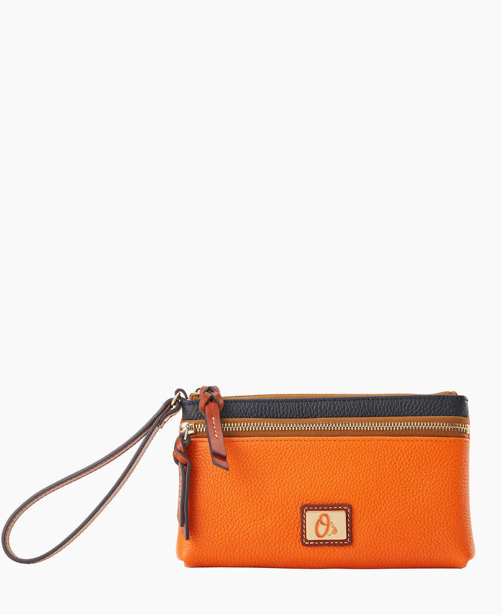 An orange leather wristlet pouch with a black zipper, gold-tone hardware, a small front logo plaque, and a brown wrist strap, set against a plain white background.