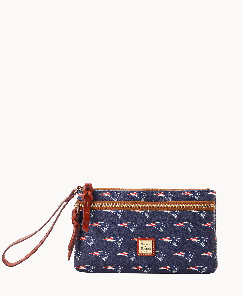 A navy blue wristlet handbag featuring a repeating pattern of New England Patriots logos, a brown leather wrist strap, gold zippers, and a Dooney & Bourke logo patch on the front.