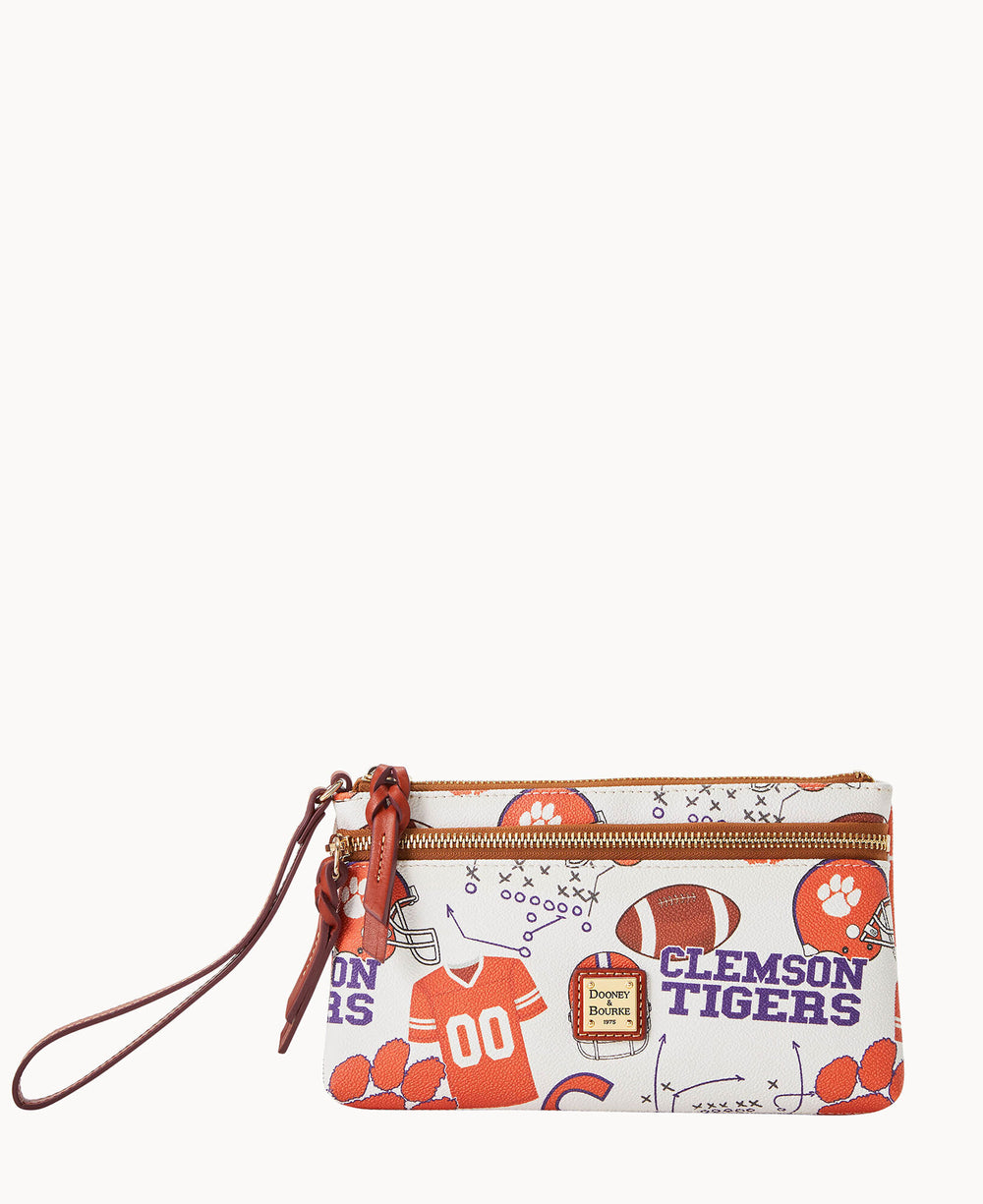 A white zippered wristlet pouch with brown strap, featuring Clemson Tigers team graphics, footballs, paw prints, a jersey, and the Dooney & Bourke logo.