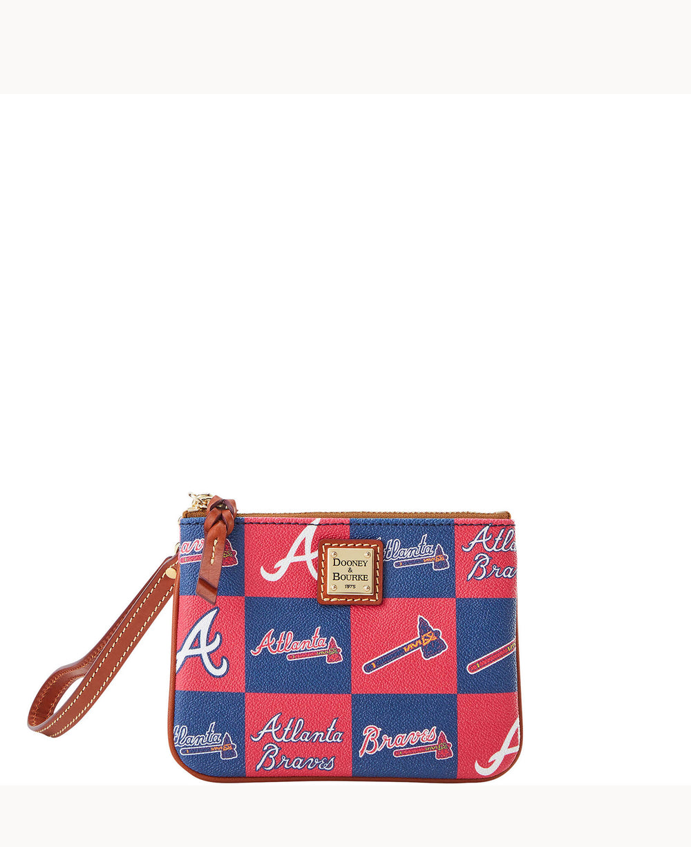 A small wristlet pouch with a blue and red checkered pattern featuring Atlanta Braves logos, tomahawks, and the Dooney & Bourke label on the front. The pouch has a brown leather strap and zipper closure.