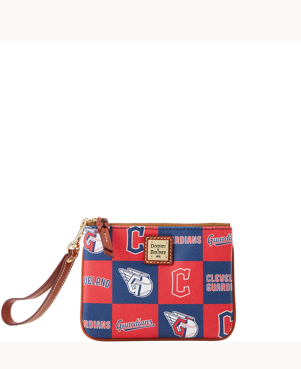 A small red and blue wristlet pouch patterned with Cleveland Guardians logos, text, and baseball motifs, featuring a brown leather strap and a gold Dooney & Bourke label on the front.