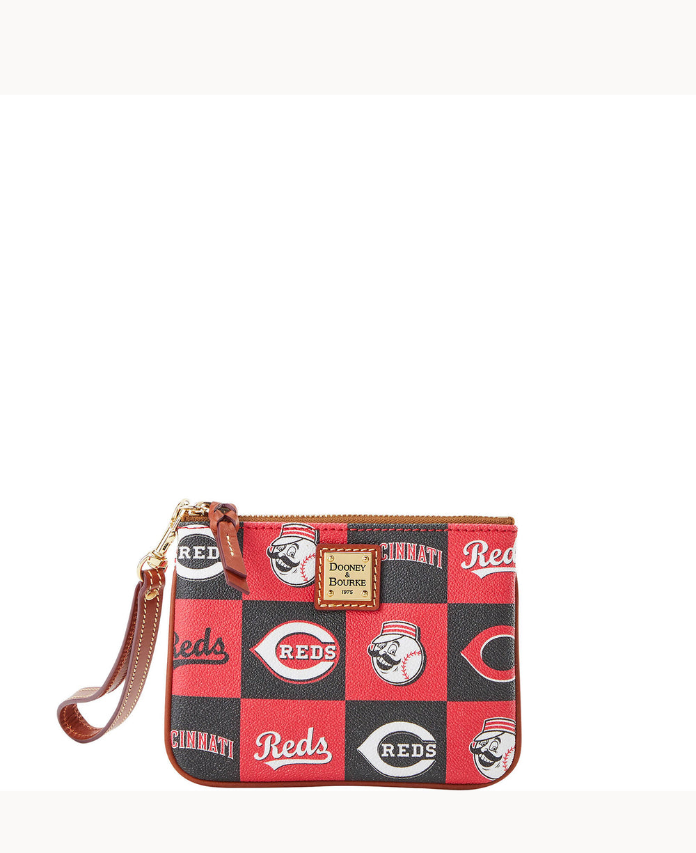 A small wristlet pouch with a Cincinnati Reds baseball team design, featuring red and black squares, team logos, and a brown leather strap and trim with a gold Dooney & Bourke label.