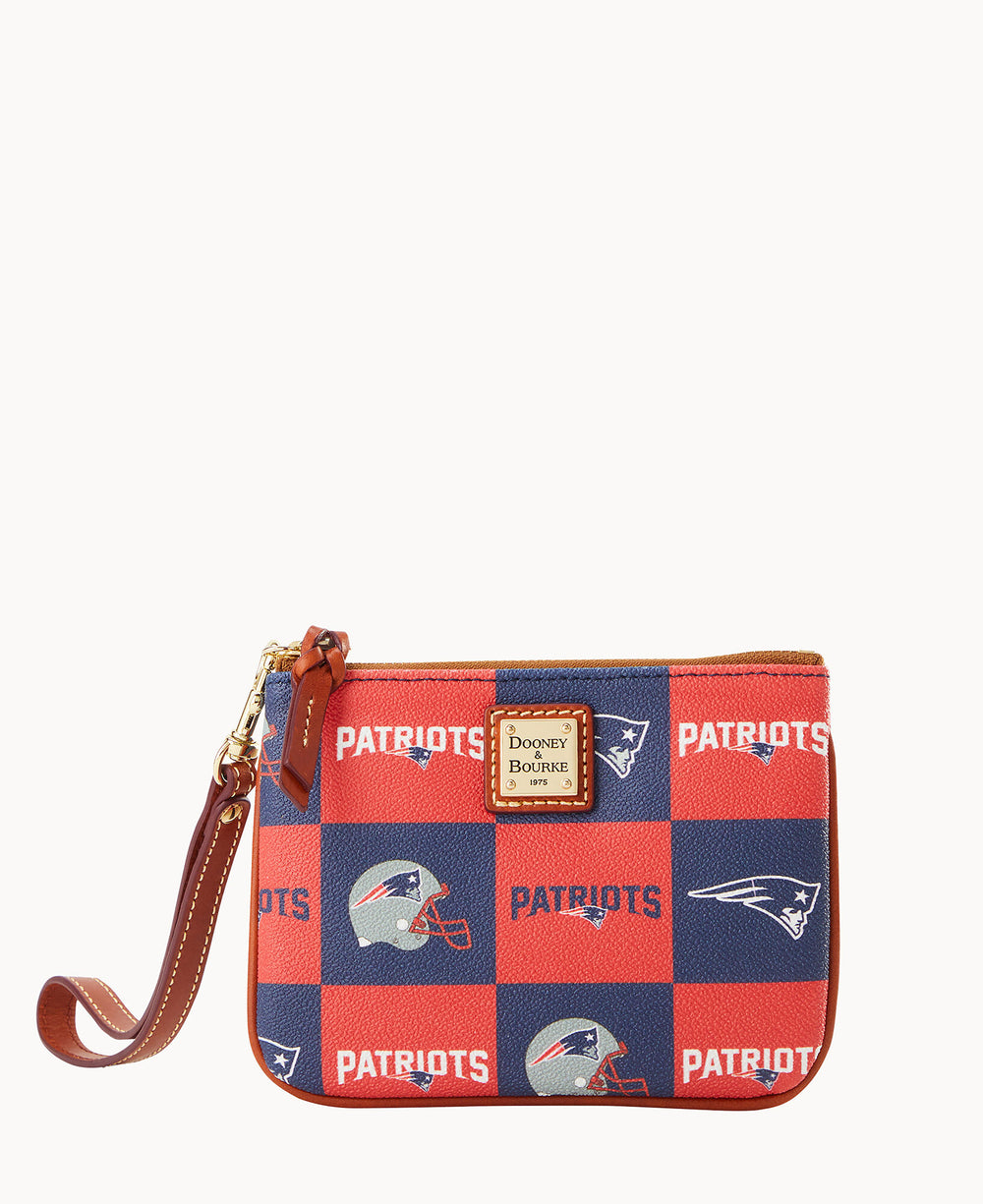A small wristlet pouch with a brown leather strap and zipper, featuring a red and blue checkered pattern with Patriots, football helmets, and the New England Patriots logo. A Dooney & Bourke label is on the front.