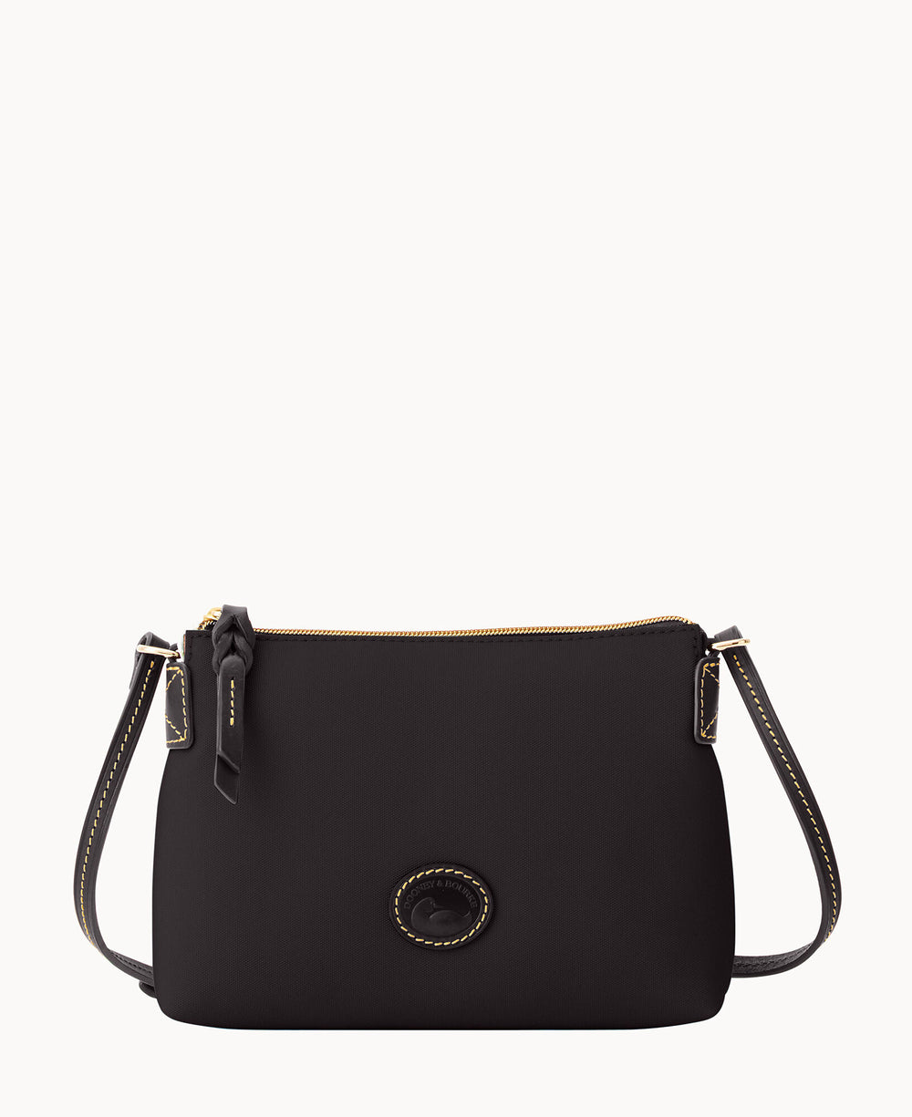 A small black crossbody bag with a gold zipper, black strap with yellow stitching, and a round logo patch on the front. The bag is set against a plain white background.