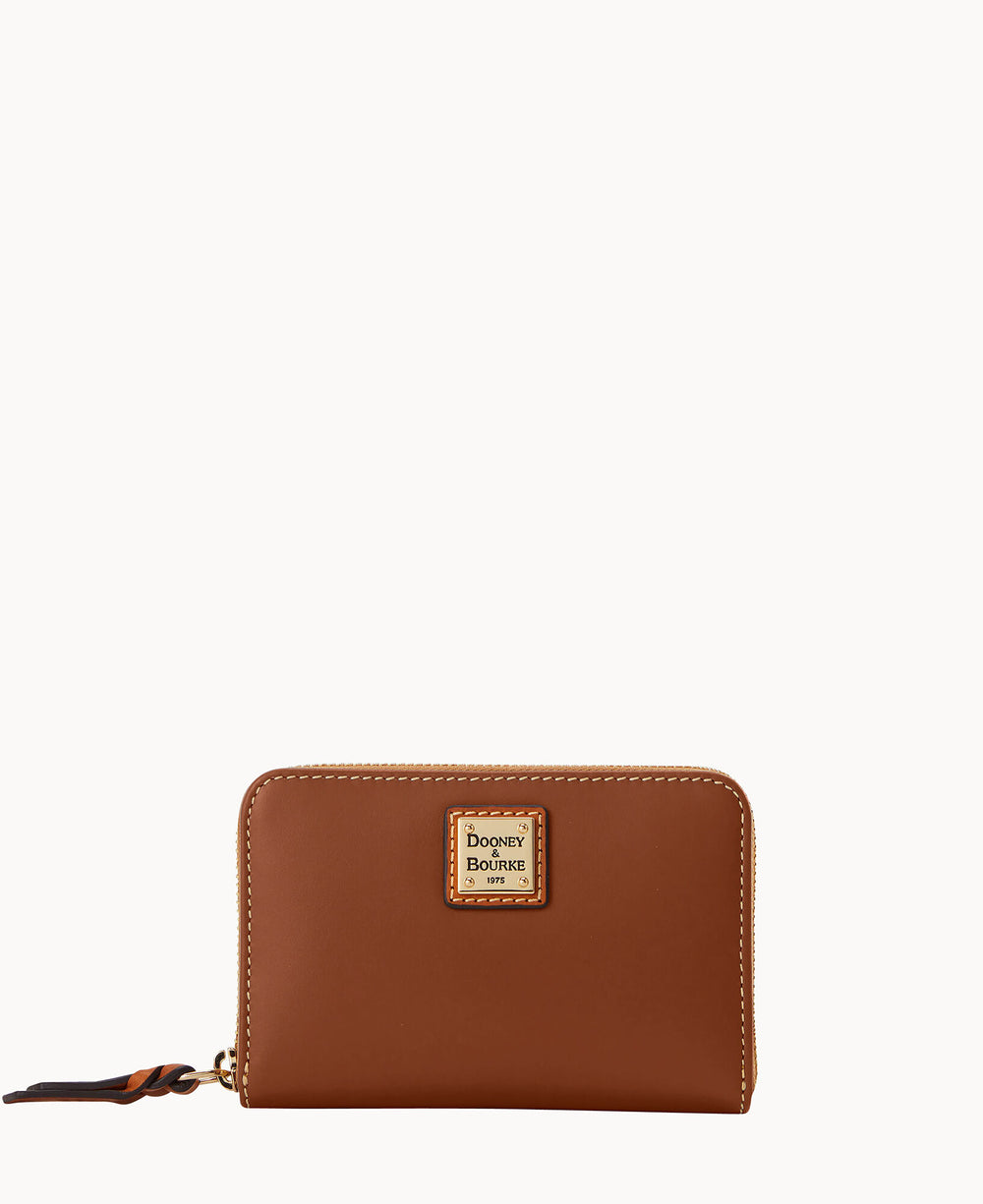 A brown leather Dooney & Bourke zip-around wallet with a gold logo patch on the front and a leather zipper pull, displayed against a plain white background.