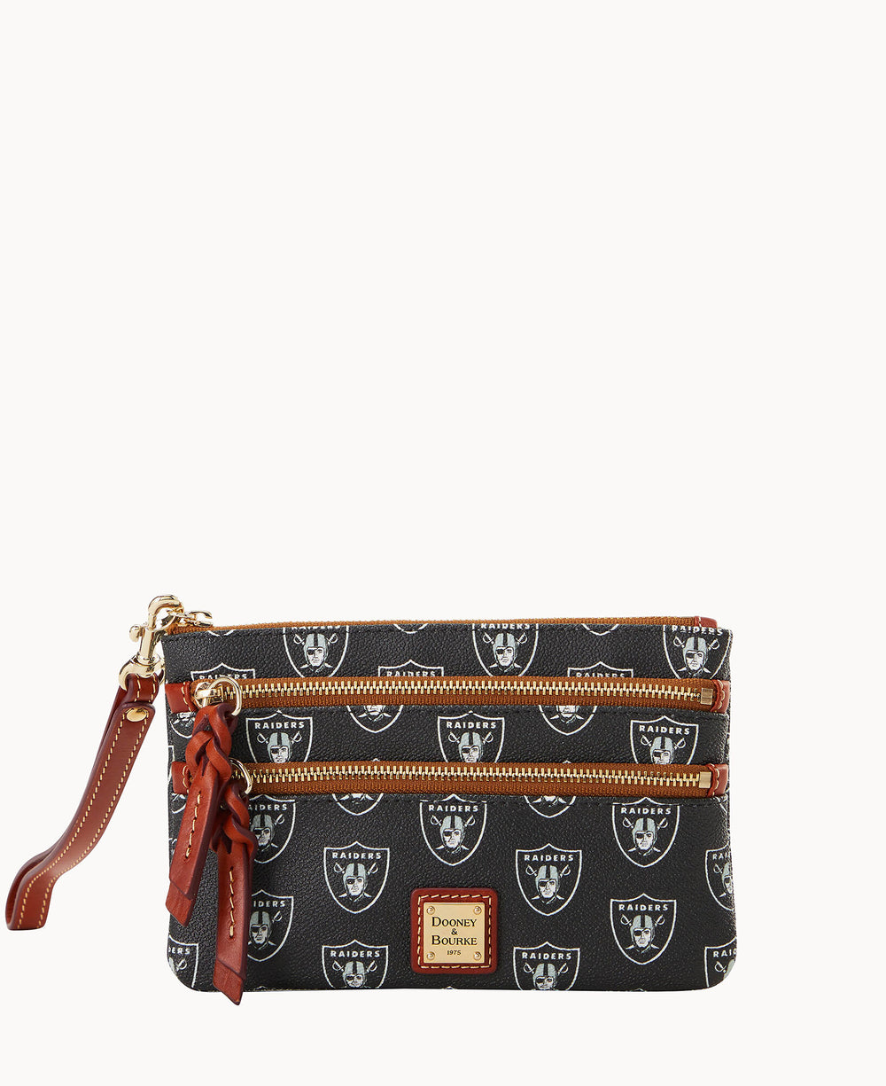 A black wristlet purse with the Las Vegas Raiders logo pattern, brown leather accents, three gold zippers, and a brown leather strap. The front features a Dooney & Bourke label.
