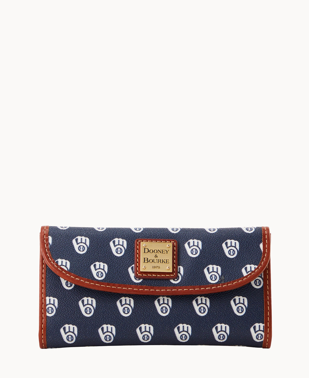 A navy blue wallet with a repeating white Milwaukee Brewers logo pattern, brown trim, and a gold Dooney & Bourke label on the front flap.