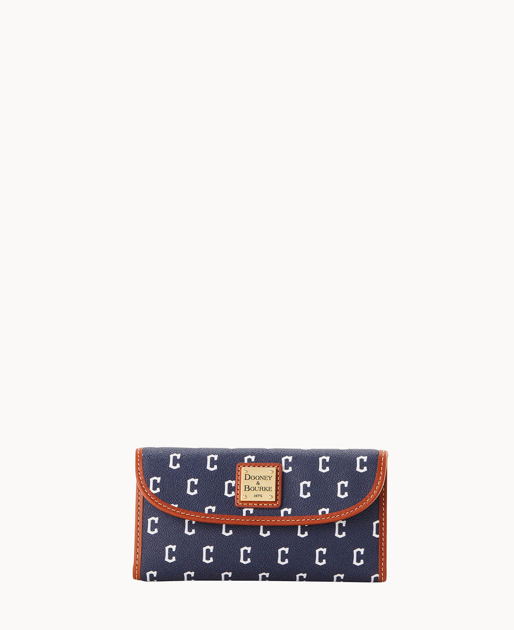 A navy blue wallet with a repeating white C pattern, tan trim, and a gold Dooney & Bourke logo patch on the front.