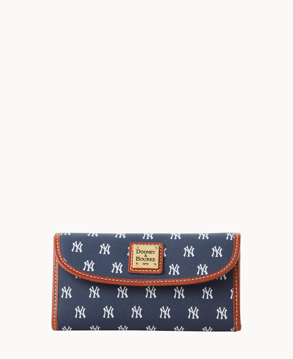 A navy blue wallet with white New York Yankees logos, brown leather trim, and a Dooney & Bourke label on the front.