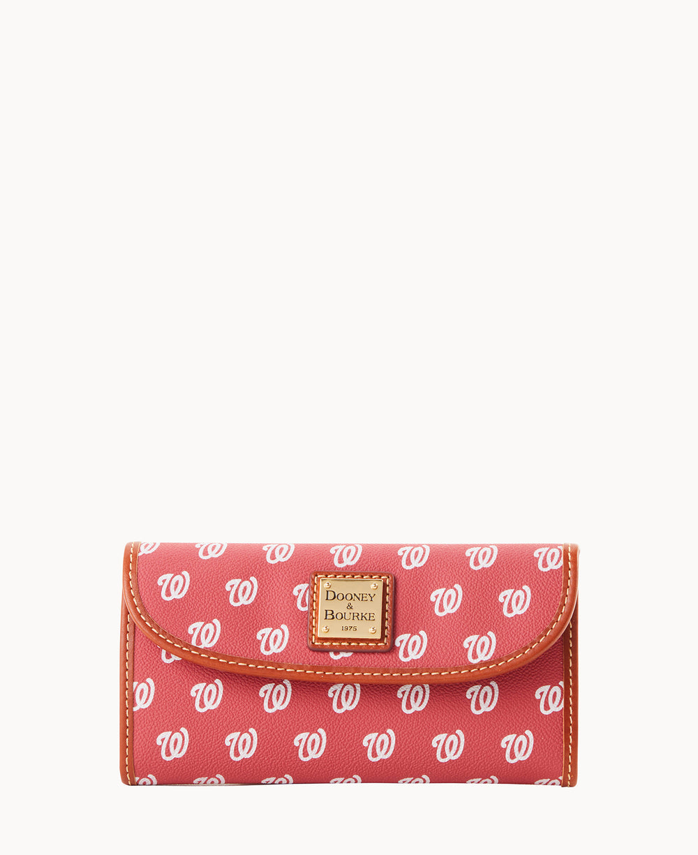 A red Dooney & Bourke wallet featuring a repeating white W logo pattern and a tan leather trim, with a gold brand label on the front.