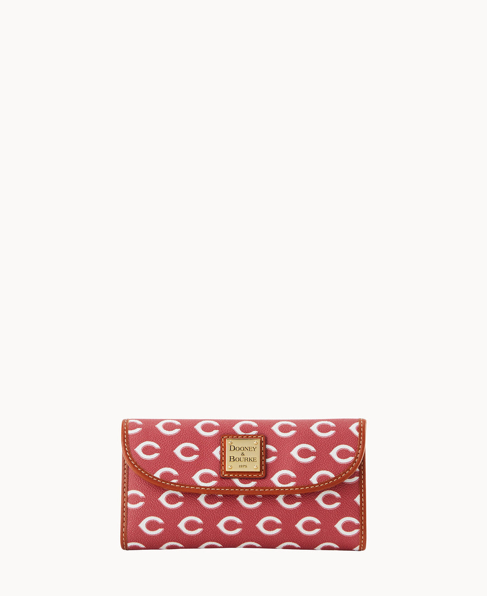 A red wallet with a repeating white C pattern and a gold Dooney & Bourke logo plate on the front flap.