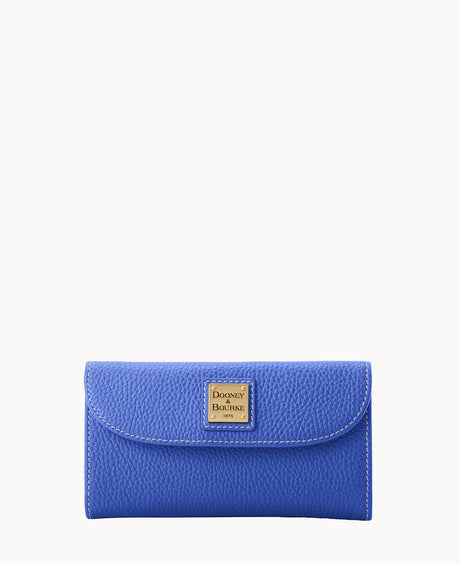 A textured blue leather wallet with a flap closure, featuring a gold square Dooney & Bourke logo plate on the front, set against a plain white background.