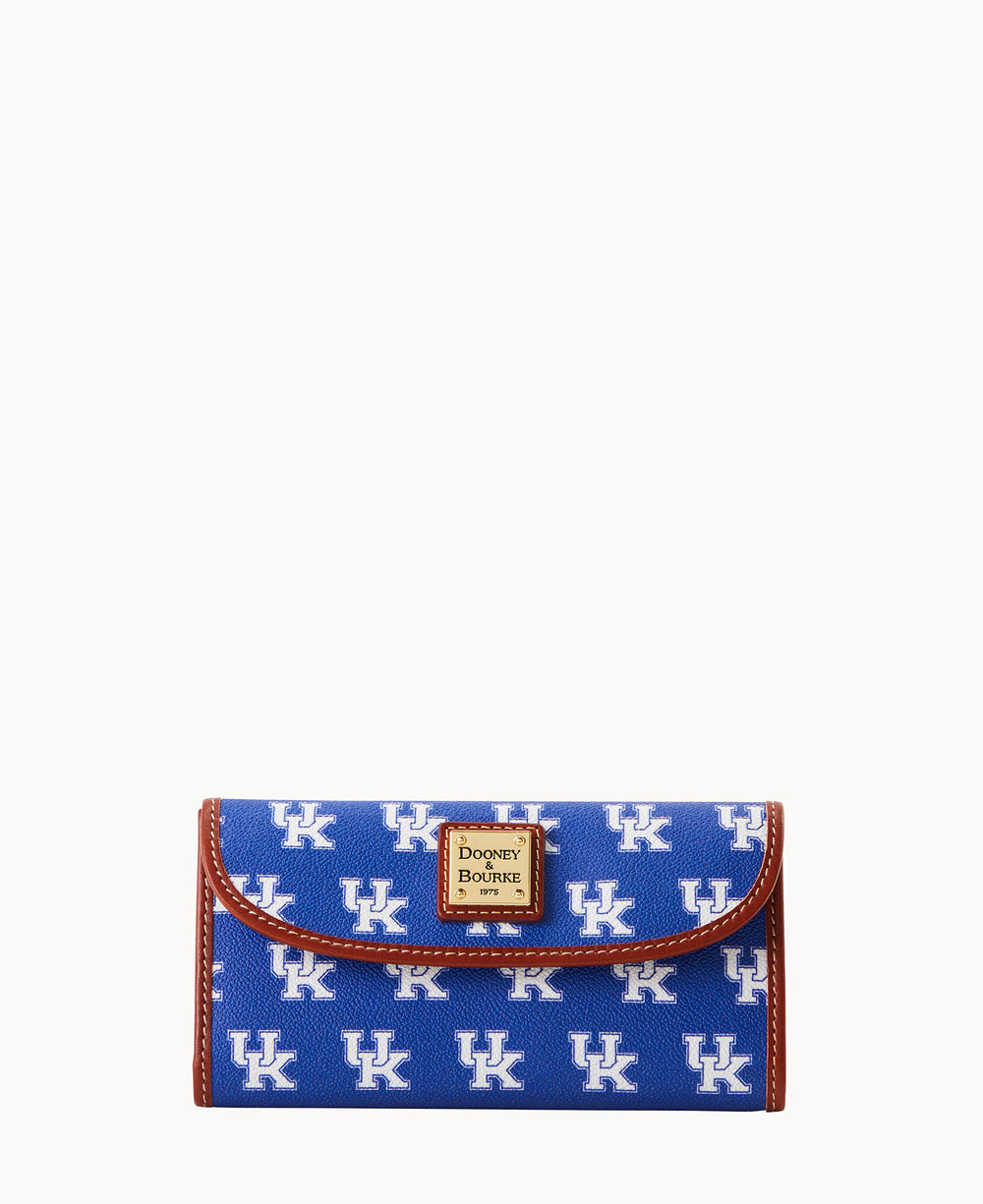 A blue Dooney & Bourke wallet featuring a repeating white UK logo pattern, brown trim, and a small gold label on the front.