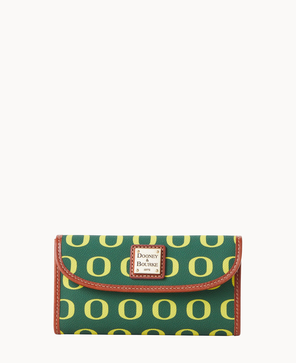 A green wallet with a repeating yellow O pattern, brown trim, and a Dooney & Bourke logo plaque on the front.