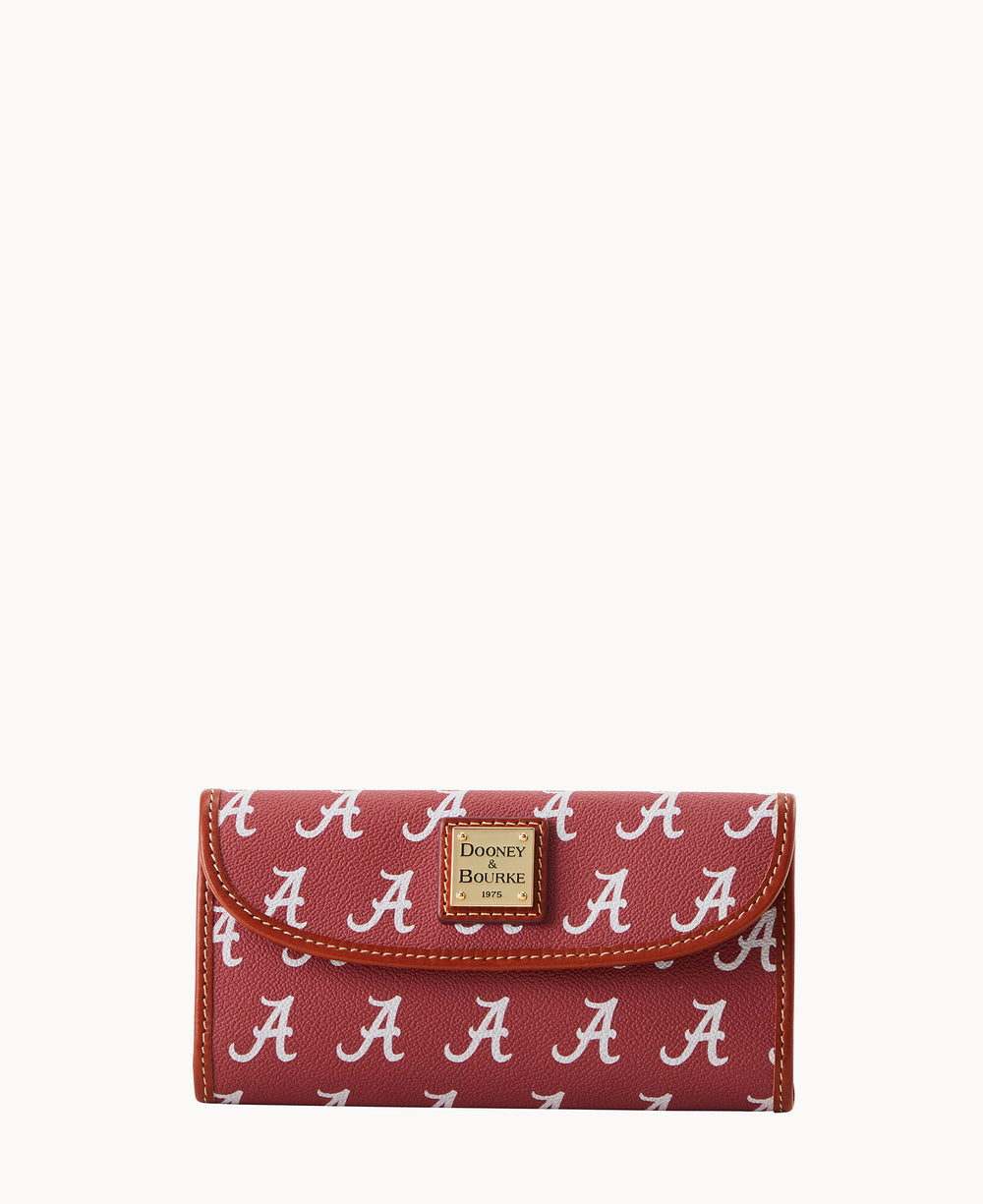 A red Dooney & Bourke wallet featuring a repeating white A pattern, with a gold logo plaque on the front and white stitching along the edges.
