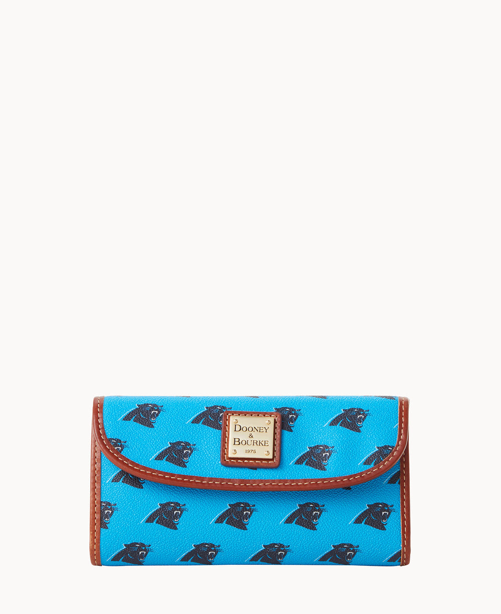 A blue Dooney & Bourke wallet featuring a repeating black Carolina Panthers logo and brown trim, displayed against a plain white background.