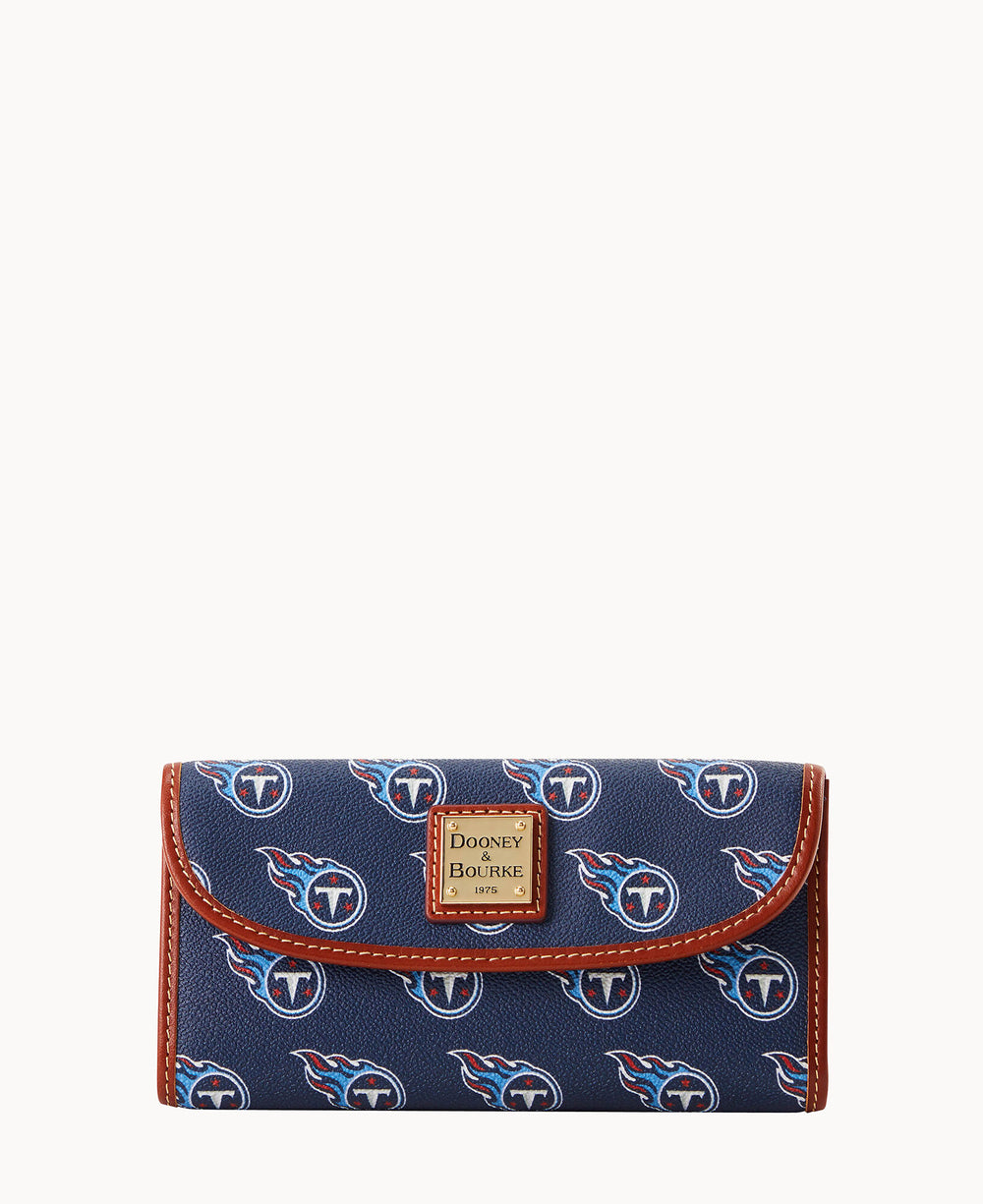 A navy wallet with brown trim, featuring the Tennessee Titans football team logo pattern and a Dooney & Bourke label on the front.
