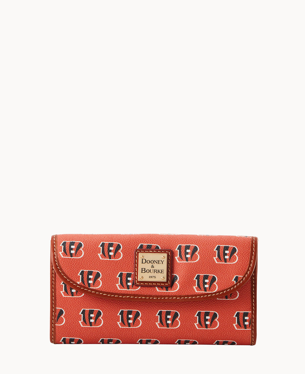 A red wallet with a repeating Cincinnati Bengals logo pattern and a gold Dooney & Bourke label on the front flap.
