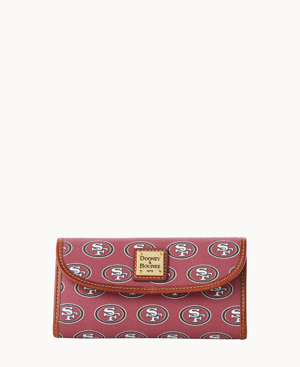 A maroon wallet with brown trim, featuring a repeating San Francisco 49ers logo pattern and a gold Dooney & Bourke label on the front.