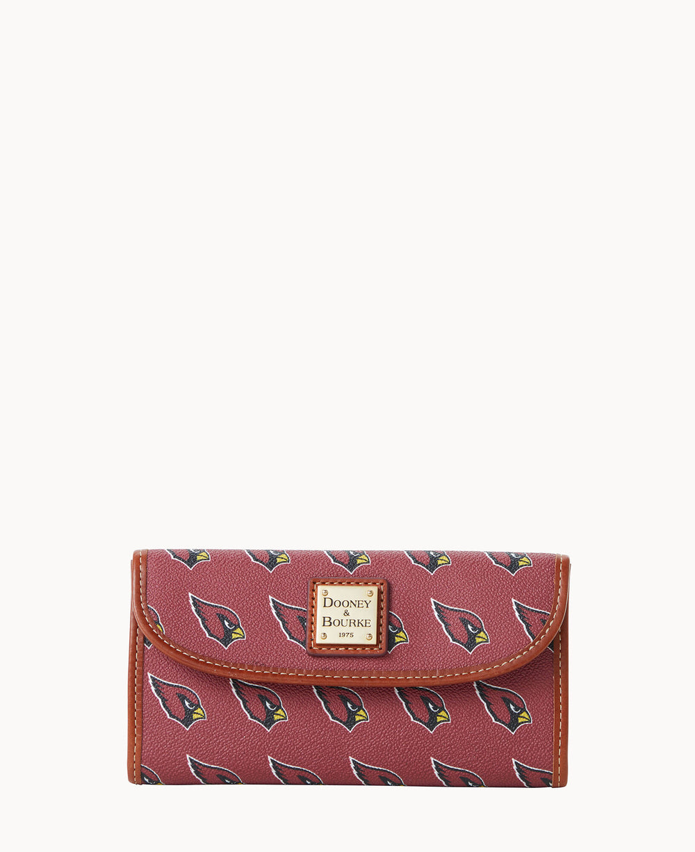 A maroon wallet with a brown trim, featuring repeating Arizona Cardinals logos and a gold Dooney & Bourke label on the front.