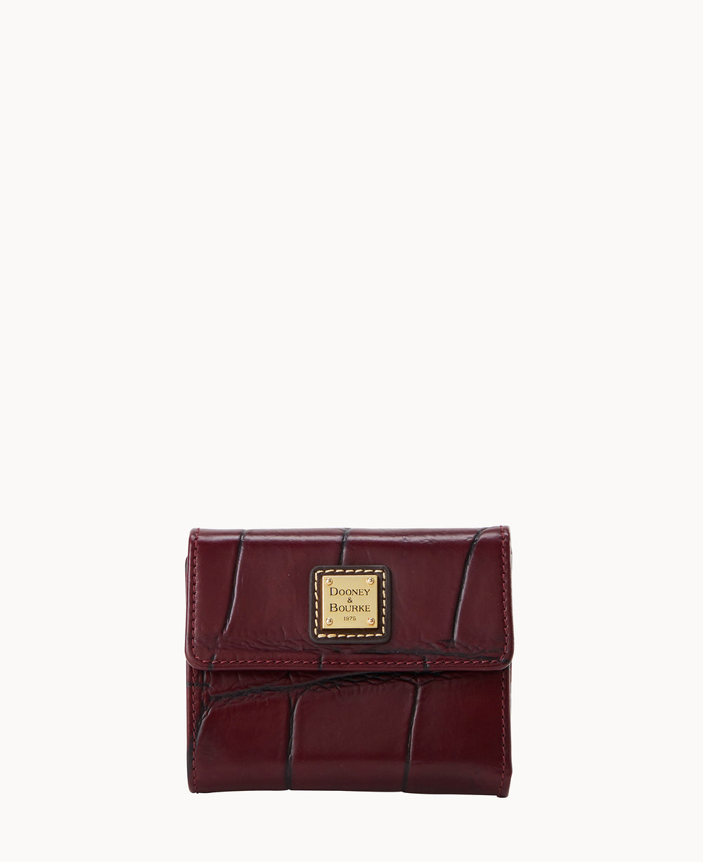 A small, burgundy leather wallet with a crocodile pattern and a gold Dooney & Bourke logo plate on the front, pictured against a plain white background.
