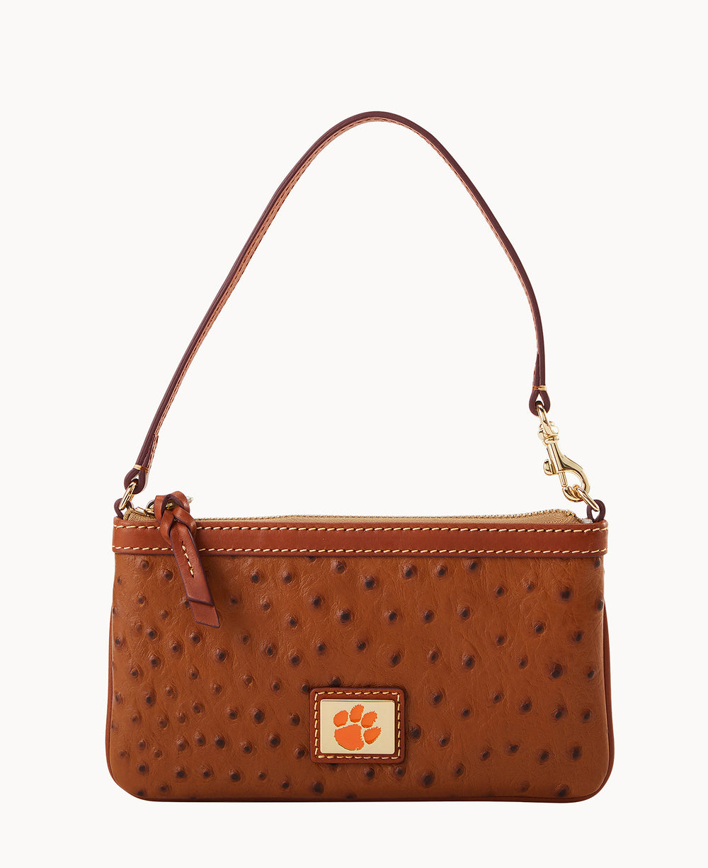 A brown leather handbag with a textured, ostrich-like pattern, a single strap, gold hardware, and a small patch featuring an orange paw print on the front.