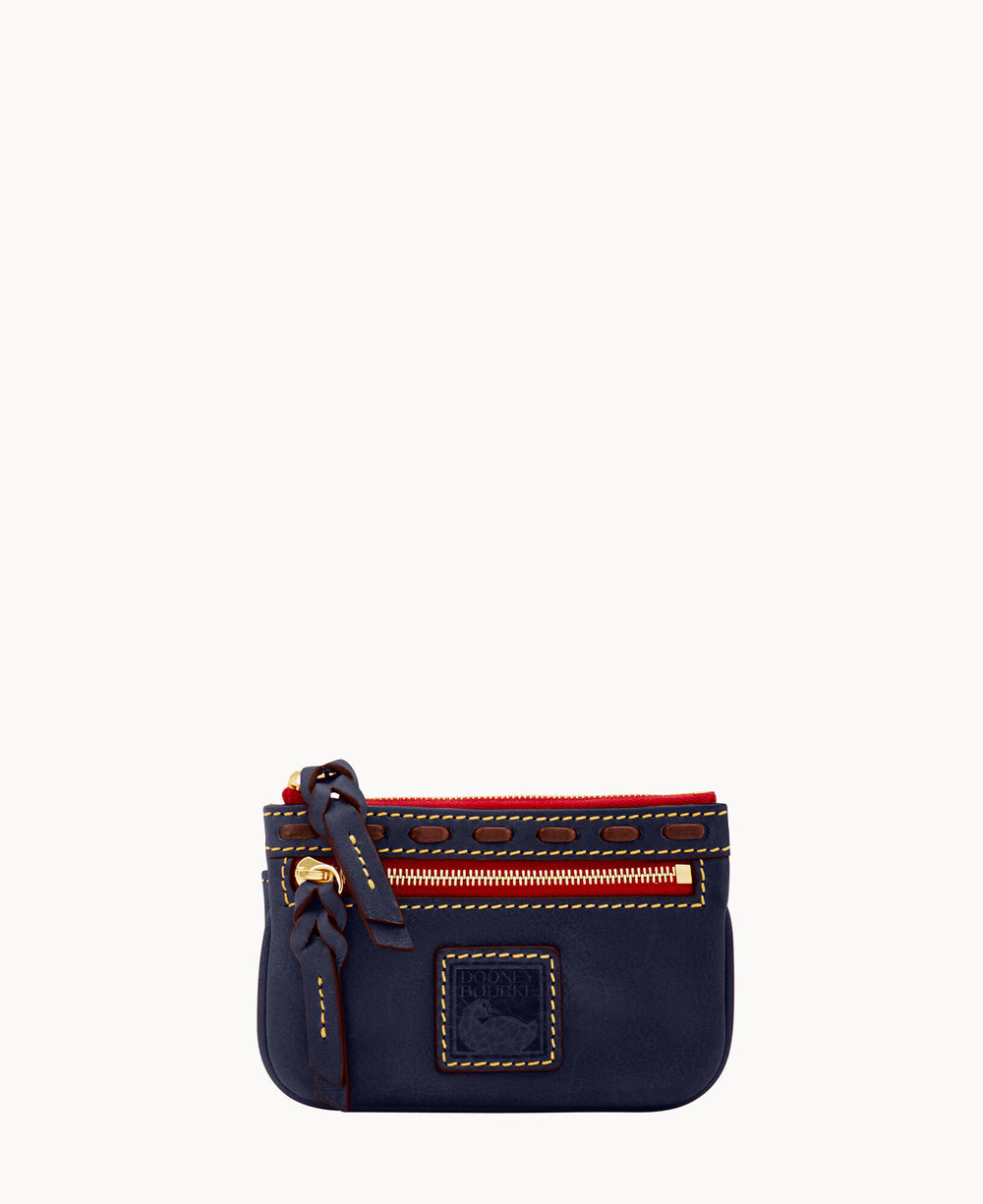 A small navy blue leather pouch with gold zipper, red accents, and a decorative knot on the side. The front features a stitched square logo patch.