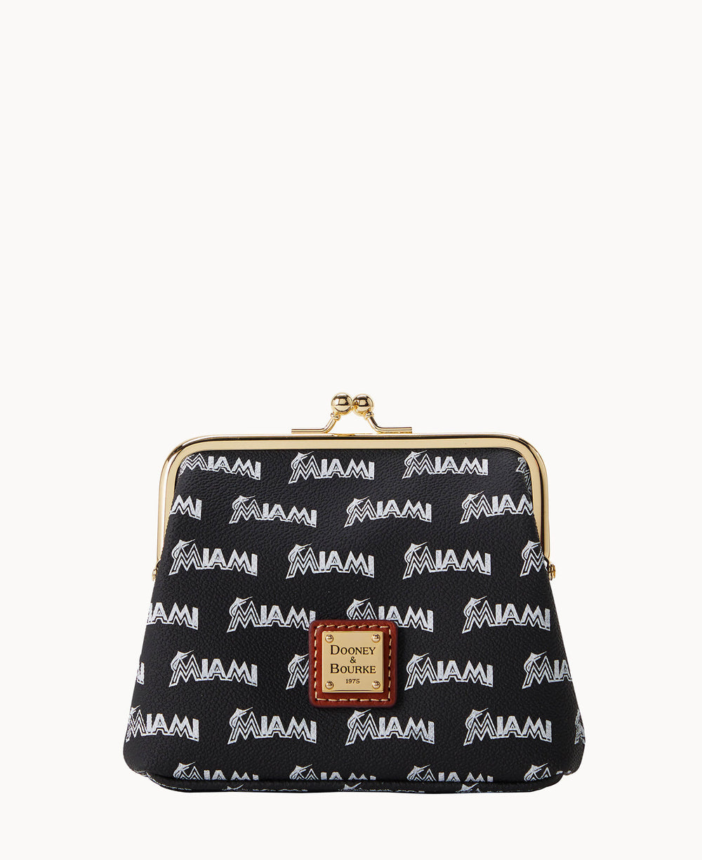 A black coin purse with a gold clasp, featuring a repeating white MIAMI and Marlins logo pattern. A brown leather Dooney & Bourke label is stitched on the front.