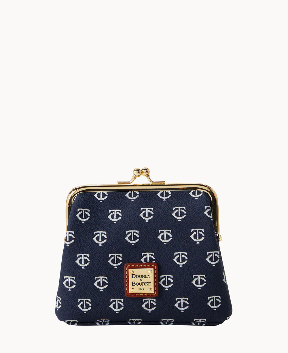 A navy blue coin purse with a white repeating pattern, gold clasp closure, and a Dooney & Bourke label on the front.