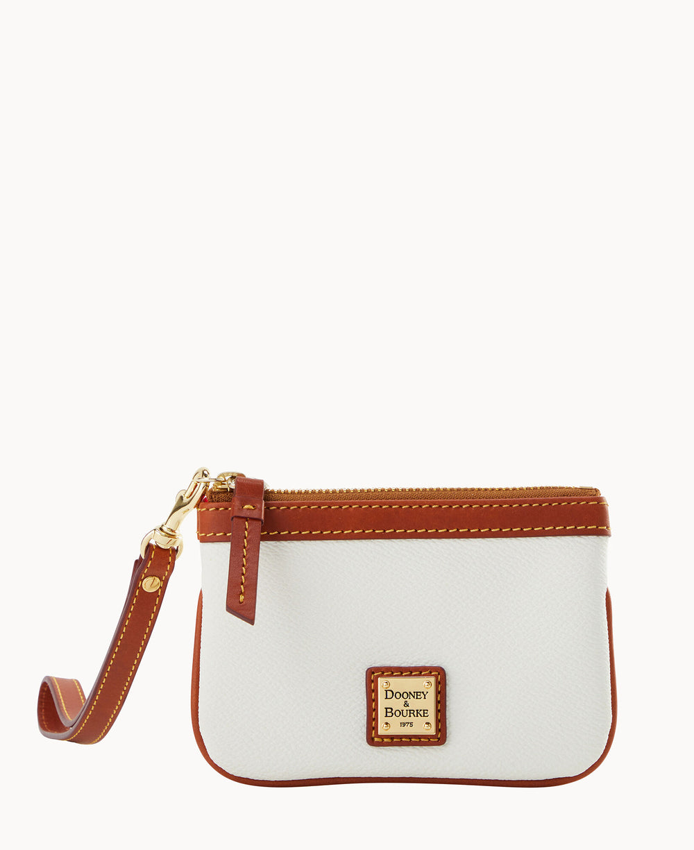 A small white wristlet pouch with brown leather trim, gold zipper, and matching brown wrist strap. The front features a square Dooney & Bourke logo patch.