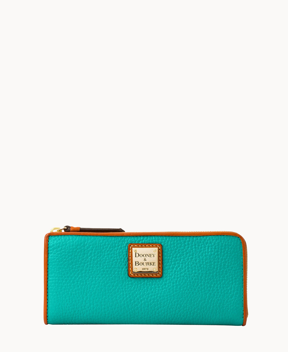A turquoise leather zip-around wallet with brown trim and a gold logo plate reading Dooney & Bourke on the front, shown against a plain white background.
